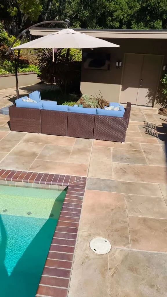Backyard pool with outdoor wicker sectional sofa
