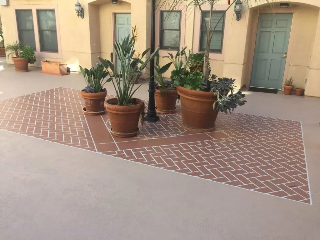 Courtyard with terracotta potted plants and lamp