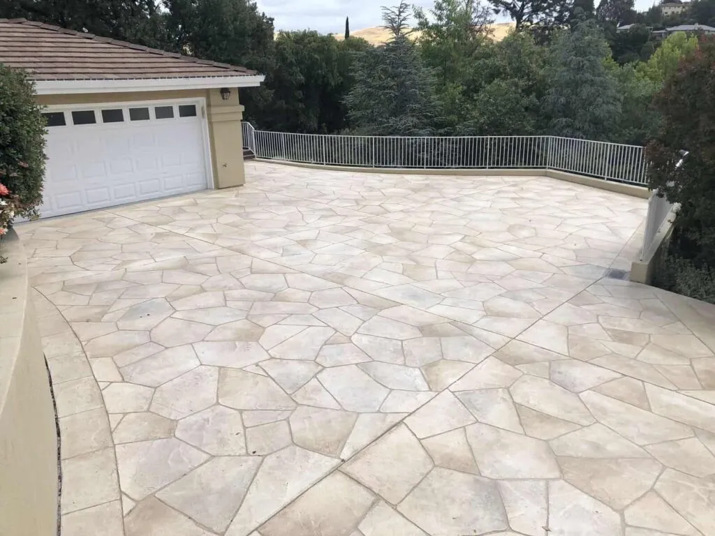 Expansive patterned stone driveway with garage