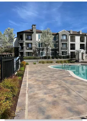 Modern apartment complex with pool and walkway