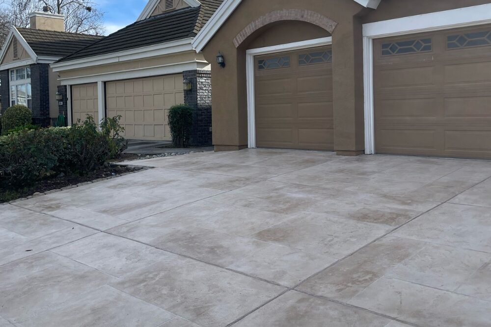 Residential concrete driveway in front of garages